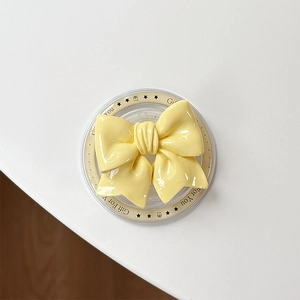 Close-up of yellow bow phone socket with Gift For You print on clear base