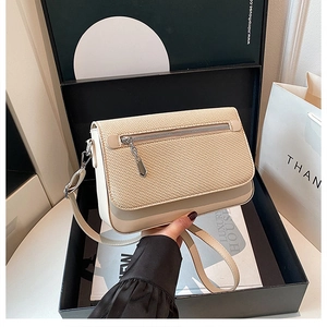 Chic beige woven leather crossbody bag presented in a black gift box with accessories