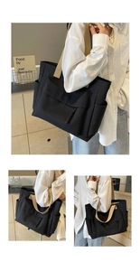 Detail of a black canvas tote bag with beige wide straps and multiple storage pockets