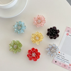 Set of seven colorful 3D floral cell phone grip holders in various vibrant pastel shades
