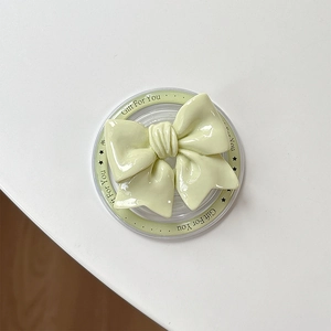 Close-up of light green bow magnetic phone socket with Gift For You printed base