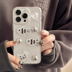 Detailed view of clear iPhone case with 3D silver fish stars and glitter accents