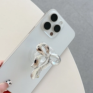 Silver bow collapsible phone grip with holographic metallic finish on white smartphone