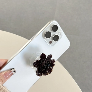 Detail of 3D purple flower phone grip with gold edges and transparent airbag base