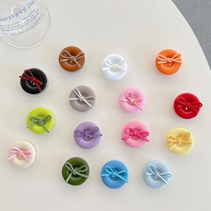 Colorful round button phone grip holders with suede bows in various solid colors