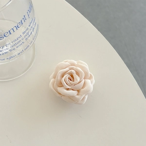 Detailed view of a creamy white fabric 3D rose phone socket with soft textile texture