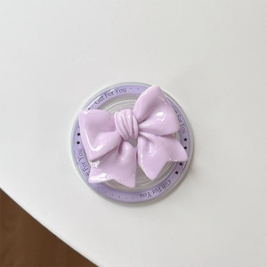 Close-up of lilac bow magnetic phone socket with Gift For You text on clear base