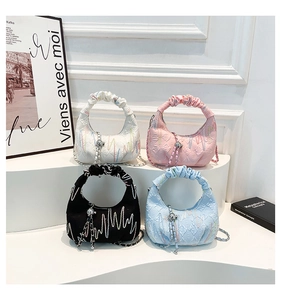 Detailed view of four pleated crescent bags in white, pink, black, and light blue colors