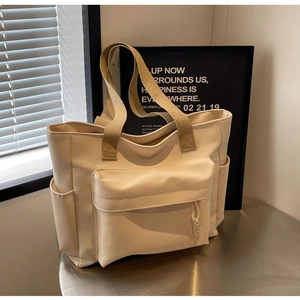 Creamy white large capacity tote bag with front pocket and side water bottle storage