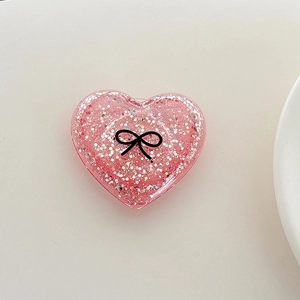 Macro shot of glittery heart phone socket featuring a cute black bow design