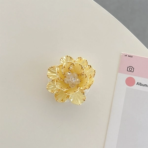 Detailed macro view of a 3D gold floral phone socket with crystal beaded center