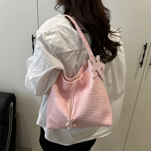 Pink woven leather shoulder bag with drawstring closure and star charm detail