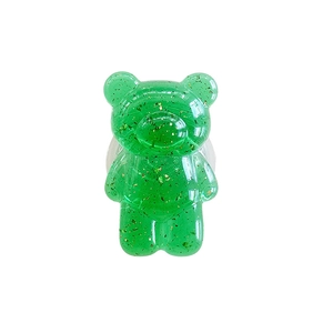 Transparent green gummy bear phone socket stand with gold foil insert on white background