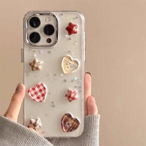Detailed close-up of iPhone case featuring 3D heart and star buttons with plaid texture