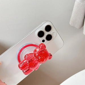 Sparkling red bear phone grip griptok with gold foil flakes on a white smartphone