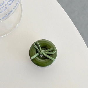 Detail view of a dark green phone socket with a matte finish ribbon bow design