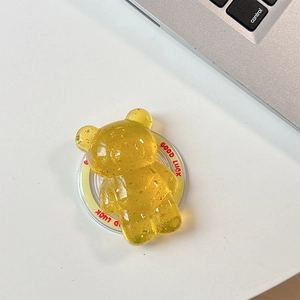 Detail of yellow translucent bear phone grip with gold foil and Good Luck base