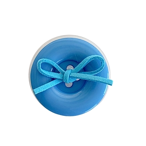 Solid blue round button phone socket with a turquoise suede bow tie on white background