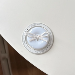 Close-up of a white button phone socket with ribbon bow and Gift For You text