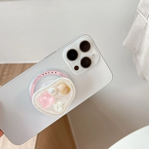 Detail of heart-shaped magnetic phone grip with cream glue, pearls and rose charm