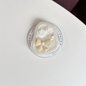 Detail of magnetic Griptok featuring 3D white roses, a pearl, and a marble bow accent