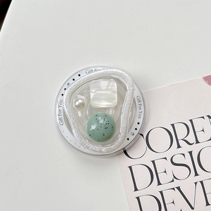 Detail of magnetic phone grip with pearl, rhinestone, and marble shell design