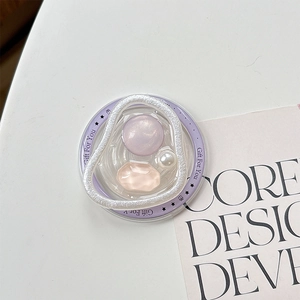 Close-up of magnetic phone grip with purple glitter and pink jewels on card