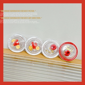 Miniature glass dome ornaments featuring festive red berries and golden coin decors