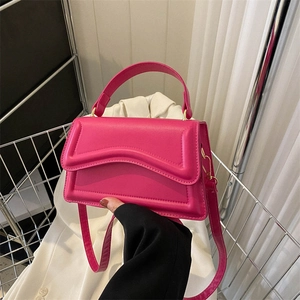Chic rose red handbag with wave-cut flap and gold hardware for modern women's fashion