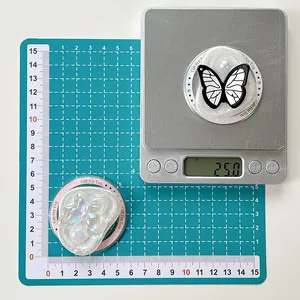 Close-up of butterfly and gemstone phone grip showing 25g weight and 5cm diameter