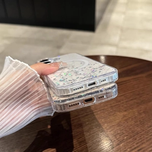Detail showing transparent iPhone case with glitter stars and magnetic charging ring