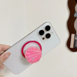 Detail of a pink glitter shell phone grip with 'Gift For You' text on the white base