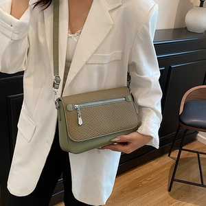 Women's two-tone crossbody bag with beige woven texture and green leather strap