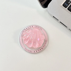 Detailed macro of a shell-shaped pink resin phone grip with glitter and 'Gift For You' text