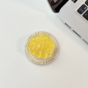 Macro detail of yellow shell phone stand with silver glitter and Gift For You text