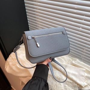 Light blue crossbody small square bag with woven flap detail and slim shoulder strap