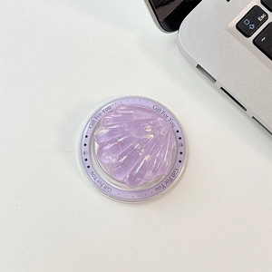 Macro detail of a purple seashell phone grip featuring glitter resin and Gift For You text