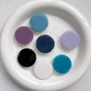 Close-up of colorful round glossy phone sockets arranged in a neat circular layout