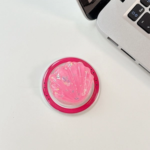 Detailed macro of pink seashell phone griptok with glitter and Gift For You text