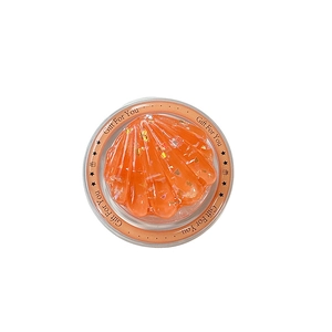 Sparkling orange shell phone grip with gold sequins in a gift box on white background
