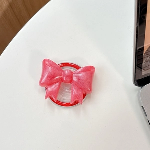 Close-up of pink glitter bow Griptok phone stand with sparkling pearl finish effect