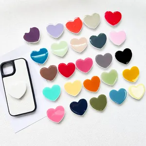 Collage of colorful heart-shaped expanding phone grips showing varied vibrant color options