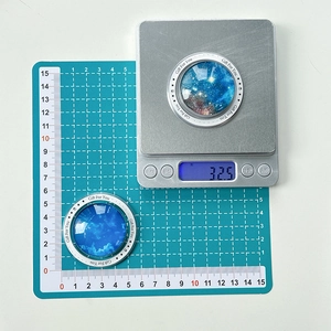 Close-up of star galaxy crystal phone grips showing 5cm diameter and 32.5g weight