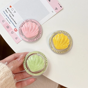 Glitter seashell MagSafe phone grip in pink, yellow, and mint candy colors with holder
