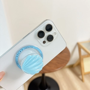 Detail of light blue shell Magnetic MagSafe phone grip with wavy texture on white phone