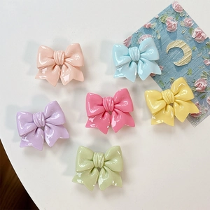 Collage of six colorful macaron bow phone socket grips in glossy resin 3D design