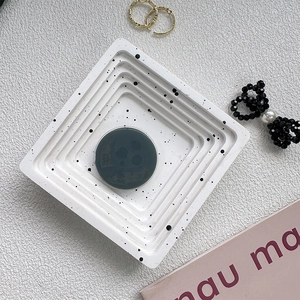 Modern square tiered white jewelry tray with black ink splatter and central holder