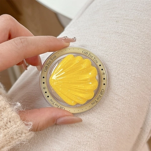 Detail view of yellow glitter shell Magsafe grip with Gift For You printed text