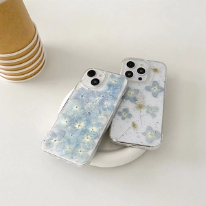 Transparent iPhone case featuring real blue dried flowers and silver foil flakes