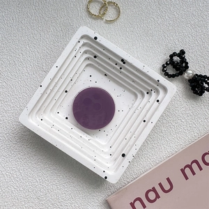 Detailed top view of purple pop socket on a polka dot tray with lifestyle accessories